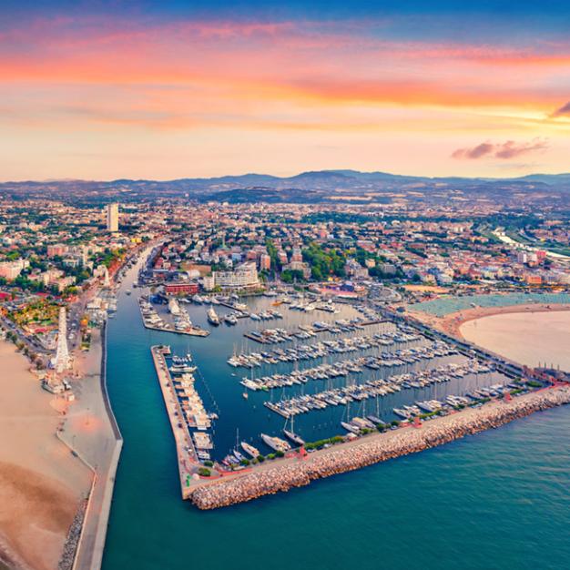 Aerial view of the marina and beach at sunset.