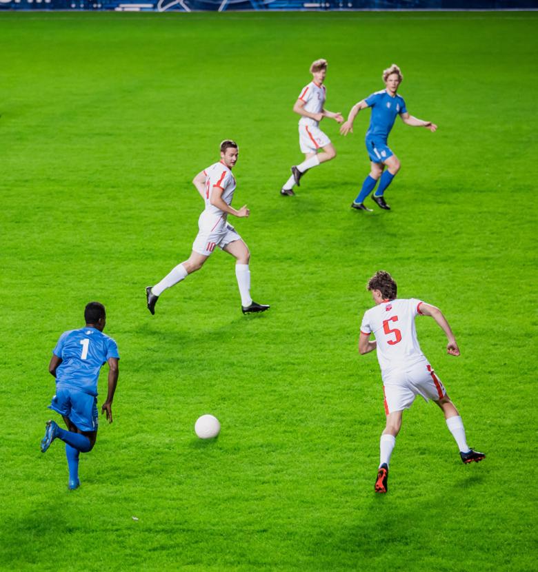 Soccer players in action on a green field during a match.